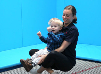 Young child and physio enjoying a rebound therapy session