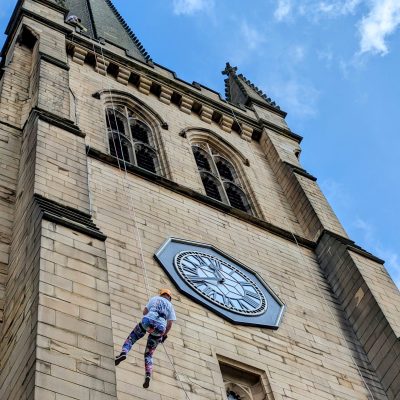 Person abseiling down large building